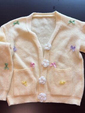 Women’s Pastel Yellow Knit Cardigan with Crochet Flower Buttons and Bow Accents